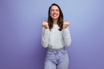 Fototapeta premium joyful lucky 25 year old brown-haired woman on purple background