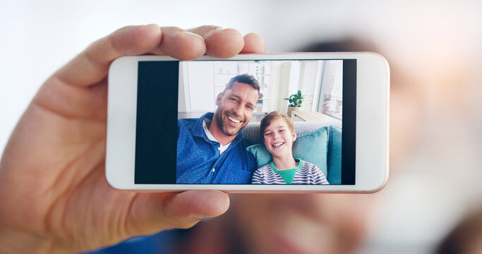 Happy father, child and smile in selfie, profile picture or social media post relaxing on sofa at home. Dad and kid smiling for photo, memory or online vlog together on living room couch in the house