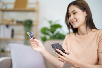 Fototapeta na wymiar Asian woman with smart phone for online shopping. Hand holding mobile phone with Payment on credit card online shopping electronic wallet Payment Shopping by phone connected card concept