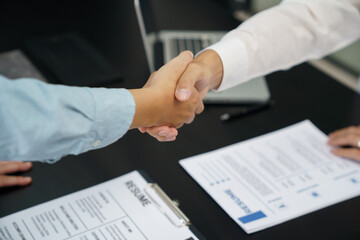 Businessman shaking hands successful candidate at interview. got the job in the team. Welcome aboard successful making a deal..partnership meeting concept.