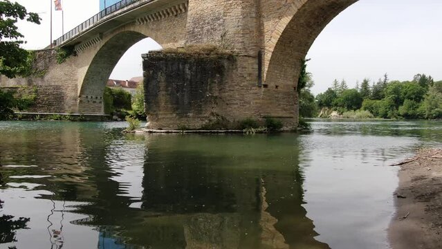 Drone idling over water under a bridge and circling a looter