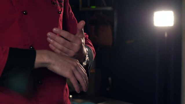 close-up of the hands of a chef speaking passionately at a master class