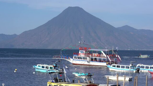 Lake atitlan in Guatemala with boats and volcanoes