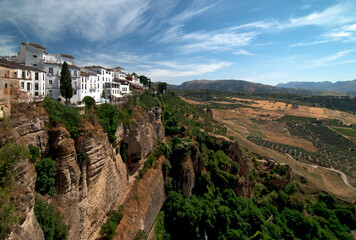 Fototapeta na wymiar Ronda, Andalusia, Spain, Europe - Famous white houses on high cliffs above picturesque Canyon El Tajo de Ronda