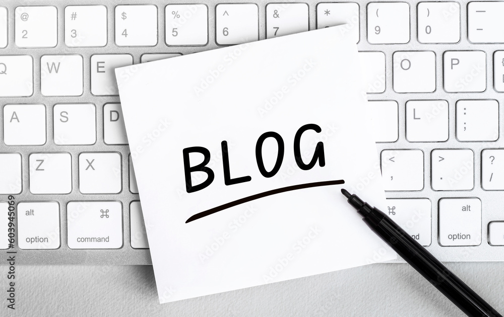 Poster white paper with text blog lying on the keyboard