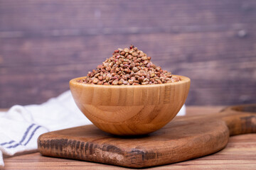Sumac seeds. Dried sumac berries on wooden background. Spice concept