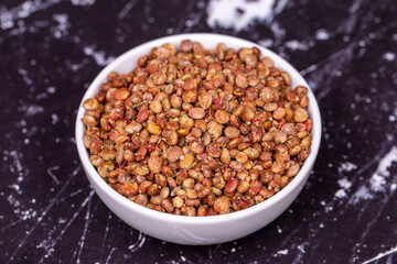 Sumac seeds. Dried sumac berries on dark background. Spice concept. Close up