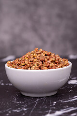 Sumac seeds. Dried sumac berries on dark background. Spice concept. Close up
