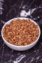 Sumac seeds. Dried sumac berries on dark background. Spice concept