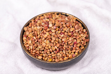 Fototapeta na wymiar Sumac seeds. Dried sumac berries on white background. Spice concept. Close up