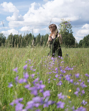 Young woman in meadow with flowers