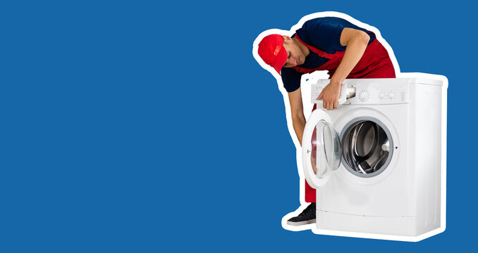 The repairman in worker suit with the professional tools box is fixing the washing machine on a blue background