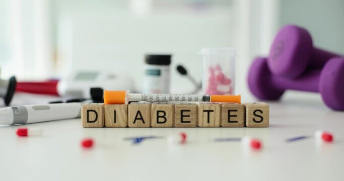 Word diabetes with insulin syringe, lancet glucometer and pills. Insulin therapy in treatment of diabetic patients