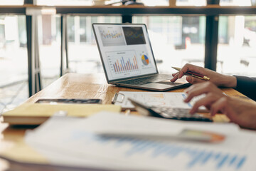 Businessmen hold graph documents to calculate financial analysis. Close-up of a businessman holding...