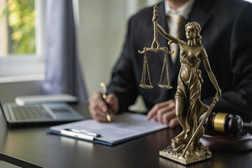 A male lawyer's office works at a desk, a law and justice concept, a legal contract.with a judge...