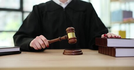 Judge hand hit with gavel in courtroom. Trial and verdict