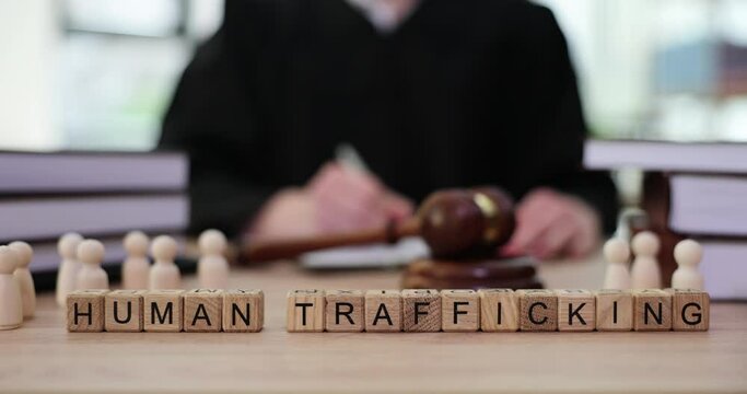 Word Human Trafficking and judge in courtroom. Slave trade and prevalence of forms of human trafficking in world
