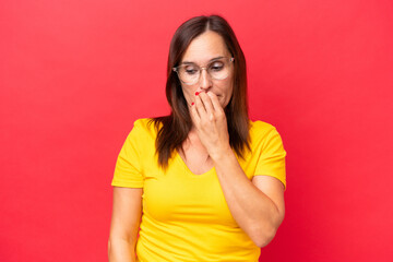 Middle-aged caucasian woman isolated on red background having doubts