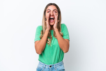 Young Uruguayan woman isolated on white background shouting and announcing something