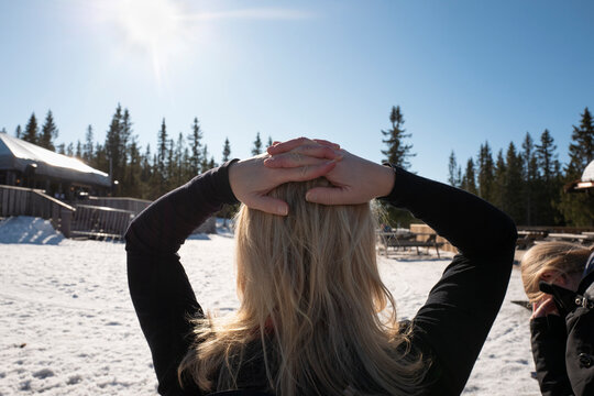 Woman with hands on head in snow