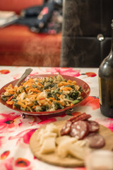 Cooked Vegetables Salami and parmesan cheese on a wooden table for dinner