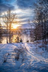 Fototapeta na wymiar Snow and river during sunset
