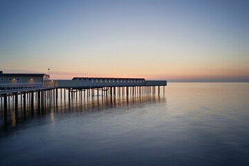 Fototapeta na wymiar Pier on sea during sunset