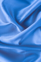 Abstract blue silk fabric texture background. Creases of satin	
