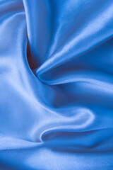 Abstract blue silk fabric texture background. Creases of satin	
