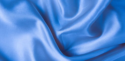 Abstract blue silk fabric texture background. Creases of satin	
