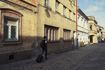 Walking down the Postavaru Street, medieval pedestrian street in the Old city of Brasov, Transylvania, Romania