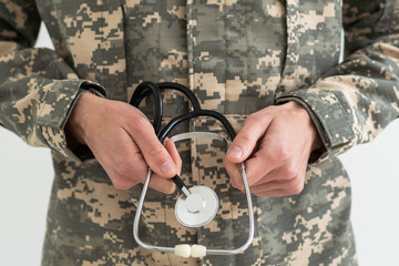 Young man army soldier holding stethoscope.