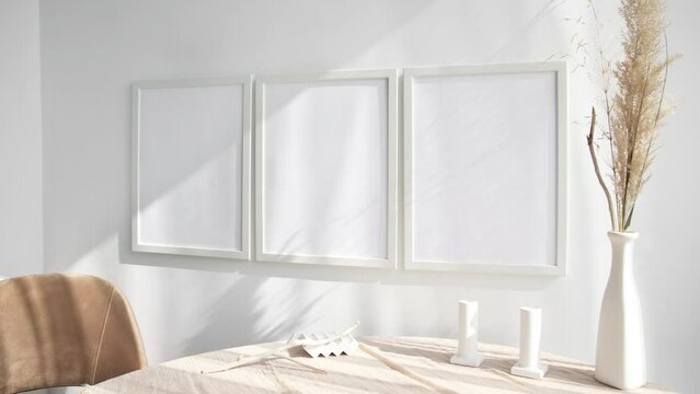 Video of three white photo frames with vase and dry flowers