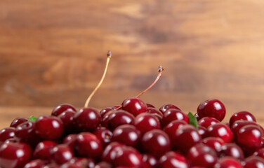 Ripe juicy cherries lie in bulk on a wooden background. Sweet cherry close-up macro. Antioxidant, natural, vitamin, organic berry. Rich harvest. Selective focus. Macro background. Shallow focus.