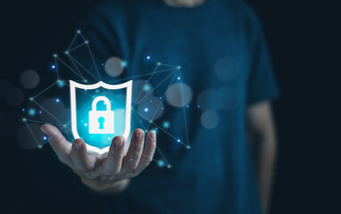 A man holding shield protect security icon on network sign background; security on the virtual display.Information security system.Cyber security safe data protection. Cool tone.