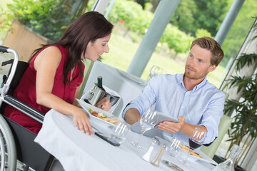 Fototapeta premium couple wheelchair having lunch
