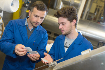 industrial tea workers inspecting the product