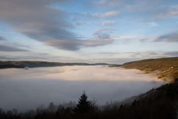 Remains of ruin Wolf Monastery or Ruine der Liebfrauenkirche in mosselle valley wine region in Germany above morning mist fog just after sunrise. dreamy fairy tale effect with natural beauty

