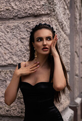 Fototapeta premium a woman in a Sicilian Italian look in a black dress