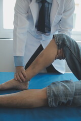 Fototapeta premium Doctor or physical therapist examines back pain and spinal area to give advice within the rehabilitation center.