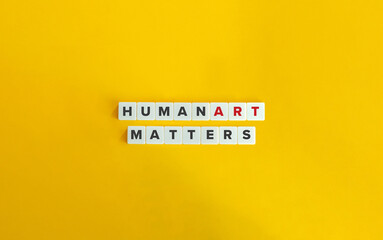 Human Art Matters. Banner and Concept Image. Block Letter Tiles on Yellow Background. Minimal Aesthetics.