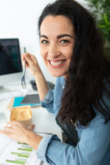 beautiful woman eating lunch in office