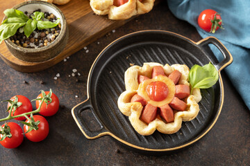 Fototapeta na wymiar Mini pizza, breakfast. Pizza in puff pastry with cheese and tomatoes on a stone table.