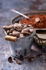 Cocoa beans put into a wooden cup of ground cocoa