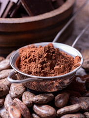 Powdered cocoa beans in a metal sieve selective focus
