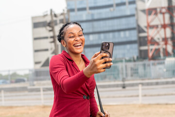 cheerful beautiful african lady checks her phone