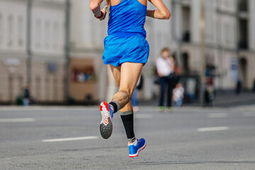 rear view male runner athlete running marathon in city, athlete jogger summer sports race, compression sleeve on feet