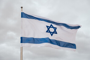 Flag of Israel in a cloudy day. 