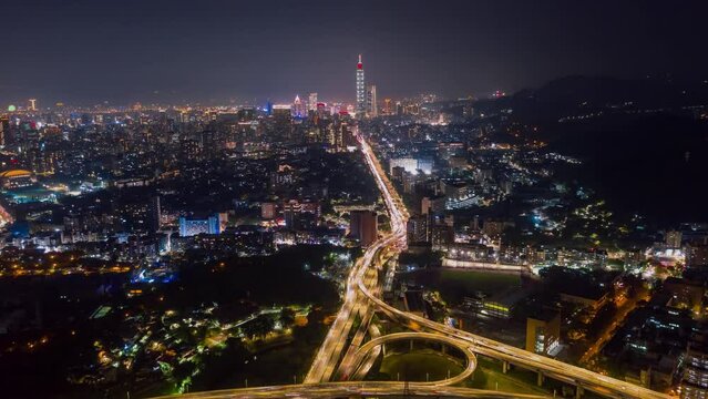 TAIWAN, TAIPEI - MAY, 2023: Aerial drone timelapse hyperlapse view of the busy traffic in city downtown streets at rush hour, with 101 Tower among crowded buildings in Xinyi District, Taipei