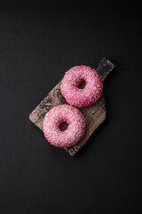 Delicious fresh sweet donuts in pink glaze with strawberry filling